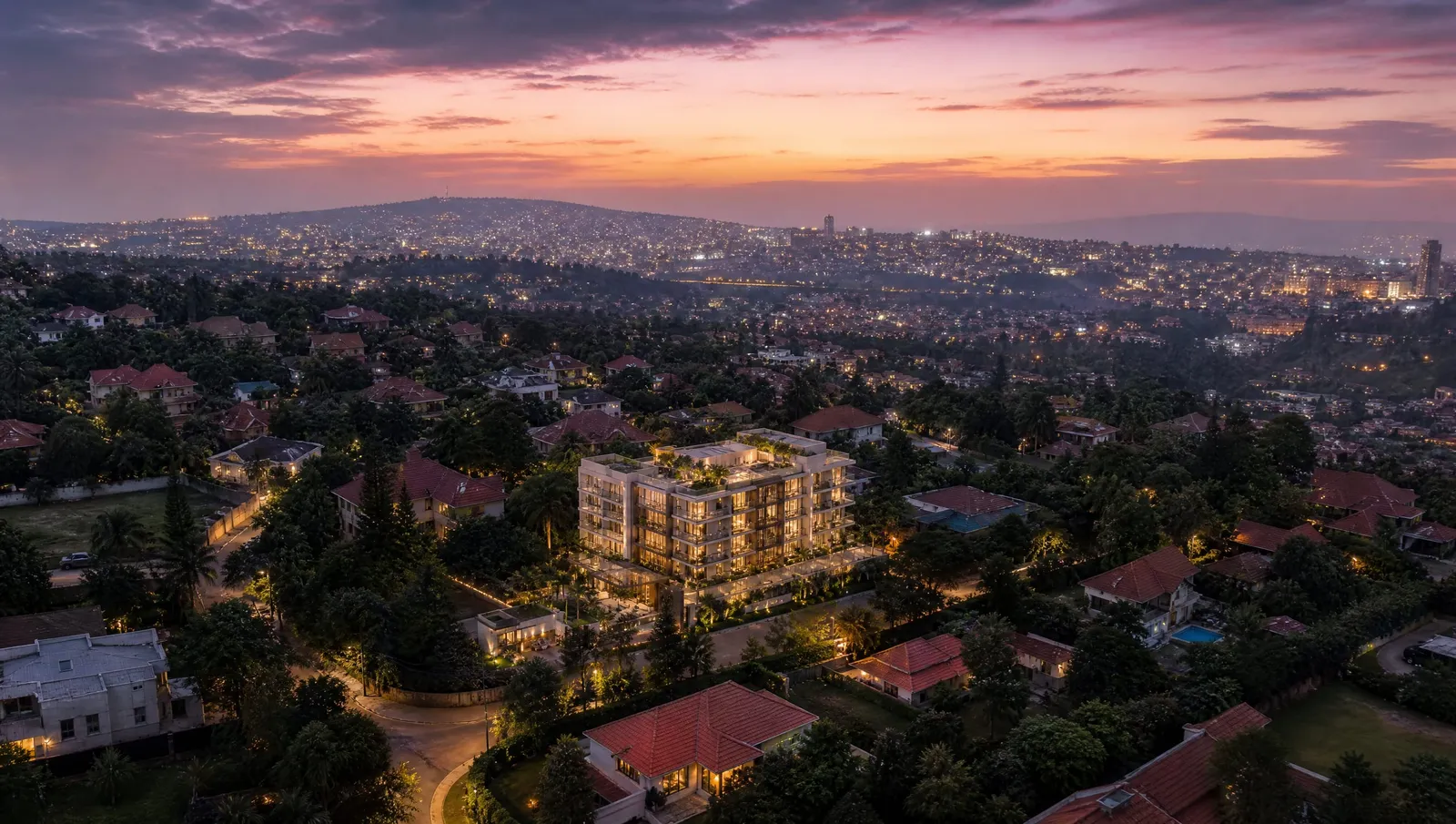 Aerial view at dusk over the green hills of Kimihurura, Kigali, with Almasi Residence on a rise in the middle distance.