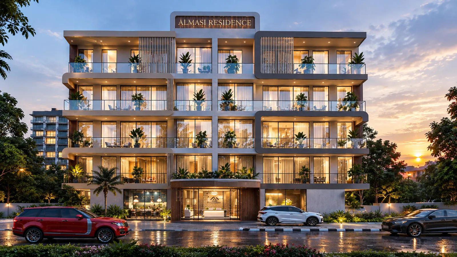 Front of Almasi Residence at dusk: the entrance, rows of lit balconies and cars parked on the street